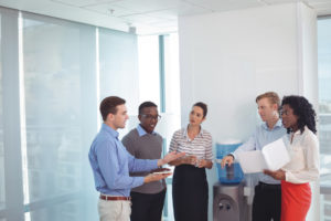 A group of people discuss business ownership in an office setting